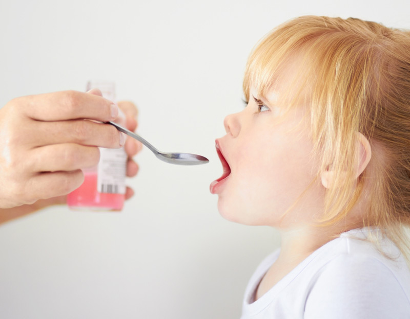 Female-child-taking-medication-from-spoon