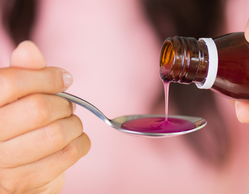 Female-hand-pouring-pediatric-medication-onto-spoon