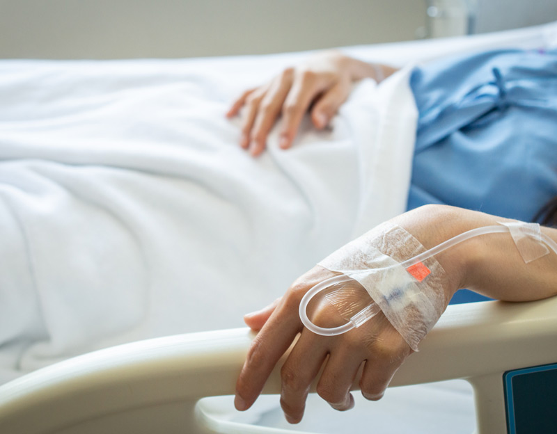 Female-patient-in-hospital-bed-receiving-IV-fluids